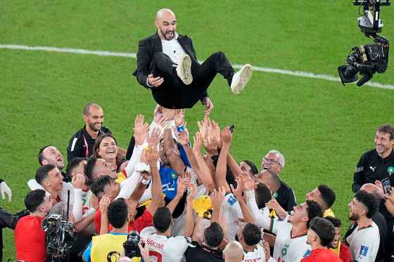 Morocco players toss head coach Walid Regragui into the air at the end of the match between Canada and Morocco in Doha, Qatar. Morocco defeated Canada 2-1 Thursday, advancing to the knockout round, while Canada was eliminated from the tournament. (Alessandra Tarantino / The Associated Press)