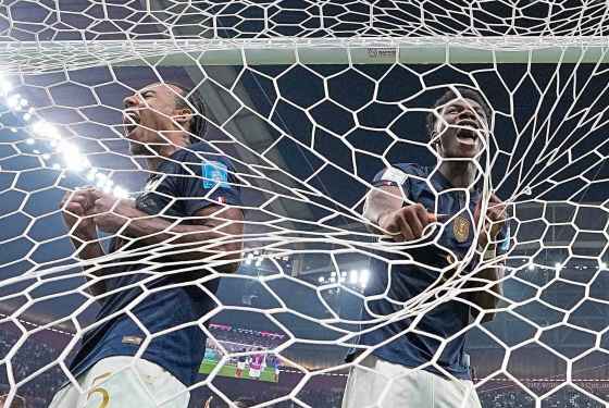 France's Jules Kounde (left) and Aurelien Tchouameni celebrate after winning the World Cup semifinal soccer match 2-0 against Morocco at the Al Bayt Stadium in Al Khor, Qatar, Wednesday. (Manu Fernandez / The Associated Press)