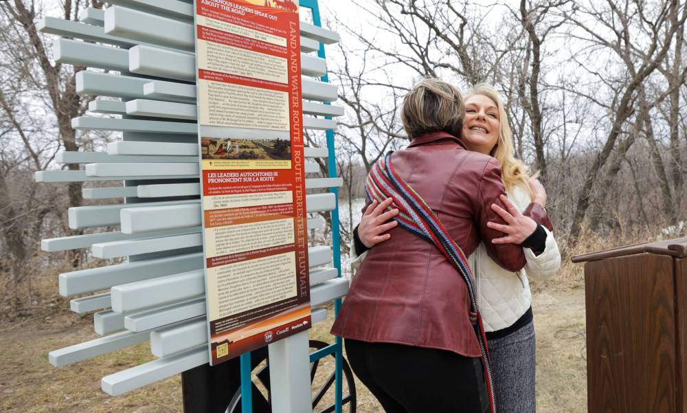 RUTH BONNEVILLE / WINNIPEG FREE PRESS
LOCAL - Dawson Trail unveiling An unveiling ceremony of a new interpretive landmark on the Dawson Trail took place along the Seine River Parkway near Provencher Blvd. Wednesday. Photo of Pierrette Sherwood (purple), Chair of the Dawson Trail Arts & Heritage Tour Initiative and Mireille Lamontagne (white), Historian of the project, celebrate as they take part in the unveiling of a new trail marker that designates the original western terminus of this first all-Canadian road to link the East and West built upon the First Nation trails thousands of years older. The Dawson Trail Commemorative Project is the culmination of a community-based, inter-regional initiative launched four years ago by volunteers of the Dawson Trail Arts and Heritage Tours with a goal to uncover and revive he rich history of the Dawson Trail in Manitoba. See Shelly’s story April 26th, 2023