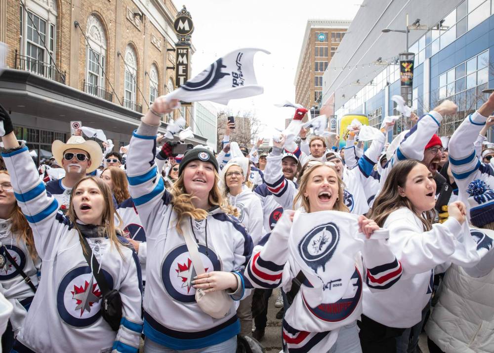 JESSICA LEE / WINNIPEG FREE PRESS From left: Clara Sydor, Senna Laflamme, Breanna Dennis, and Nikki Slywchuk cheer for the Winnipeg Jets at a Whiteout party. Thousands of Winnipeg Jets fans gathered downtown beside Canada Life Centre April 22, 2023 to watch the Jets play against the Golden Nights at a Whiteout party. Reporter: Ben Waldman