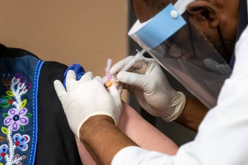 A COVID vaccine is administered by needle. (Daniel Crump / Free Press files)