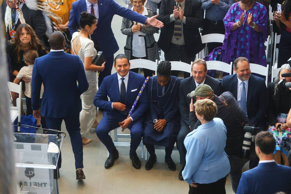 Premier-designate Wab Kinew (in aisle seat) and members of his cabinet along with attendees at the swearing-in ceremony. (Mike Deal / Winnipeg Free Press)