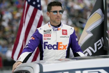 FILE -Denny Hamlin during driver introductions before the NASCAR Daytona 500 auto race at Daytona International Speedway, Sunday, Feb. 19, 2023, in Daytona Beach, Fla. Roger Penske achieved something this season the pioneering motorports magnate had never done in his long, accomplished career with back-to-back NASCAR championships. (AP Photo/John Raoux, File)