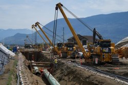 Workers lay pipe during construction of the Trans Mountain pipeline expansion, in Abbotsford, B.C., on Wednesday, May 3, 2023. The Canada Energy Regulator has released its reasons for refusing a request by Trans Mountain Corp. for a pipeline variance. THE CANADIAN PRESS/Darryl Dyck