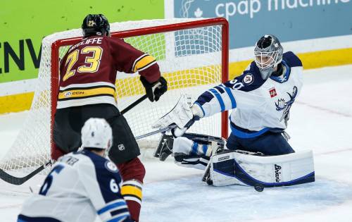 JOHN WOODS / WINNIPEG FREE PRESS
                                Manitoba Moose goaltender Collin Delia saves a shot from Chicago Wolves’ Isaac Ratcliffe during the first period in Winnipeg on Tuesday.