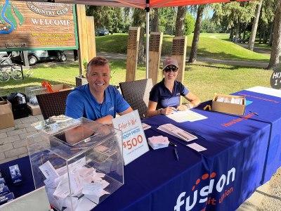 Fusion Credit Union employees volunteering at its golf tournament.
