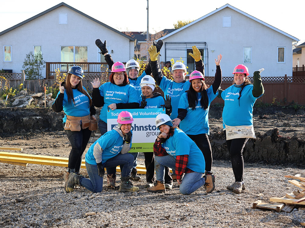 Johnston Group employees volunteering with Habitat for Humanity to help build affordable housing.