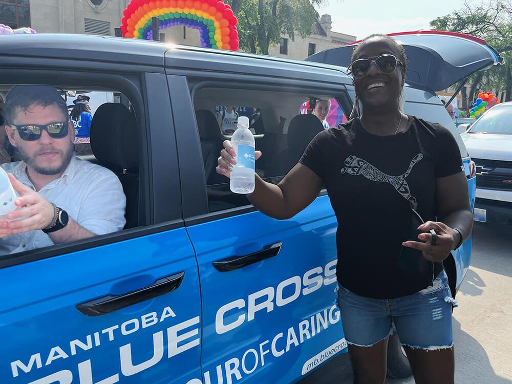 Manitoba Blue Cross employees beating the heat at the Winnipeg Pride Parade.