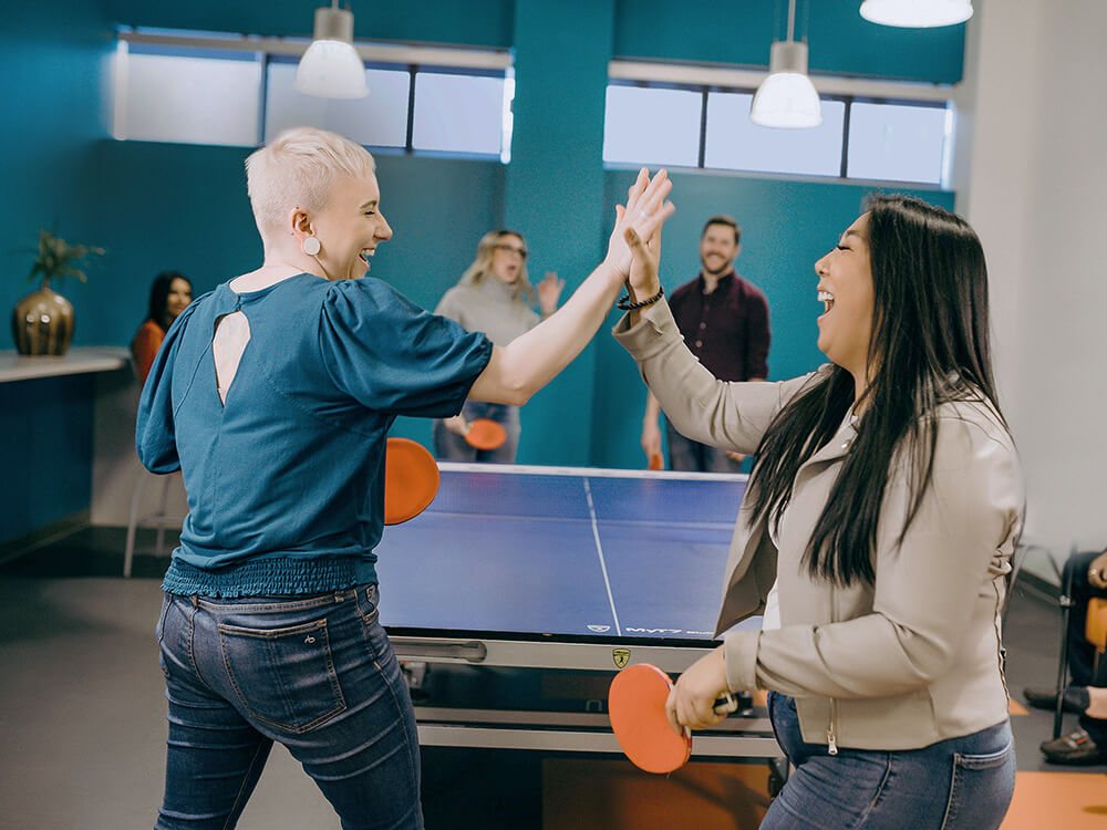 Payworks employees bonding over table tennis in its office.