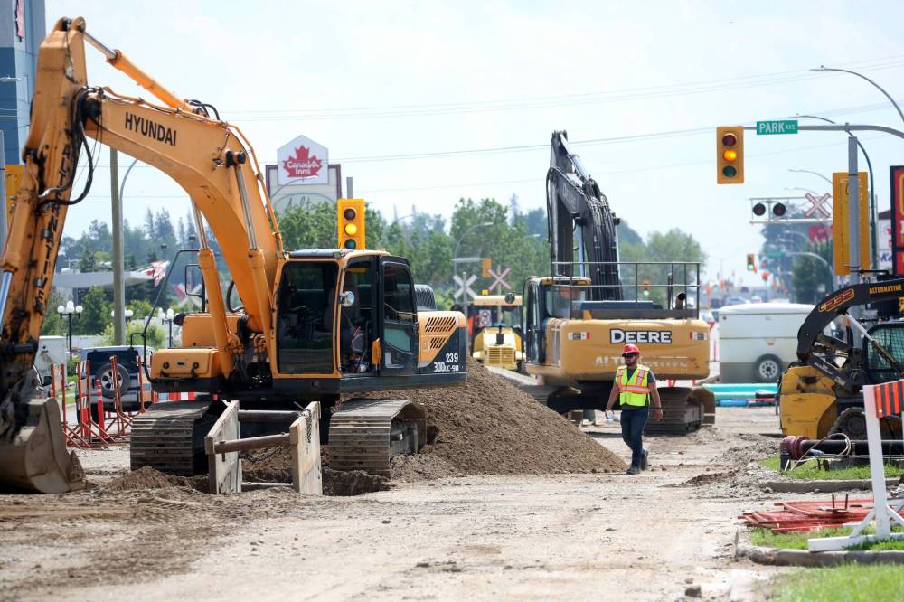 Construction workers complete repairs to underground water and sewer mains along 18th Street in July. The province announced it will spend $9.7 million to rebuild a deteriorated portion of Brandon’s 18th Street, part of Highway 10. (File)