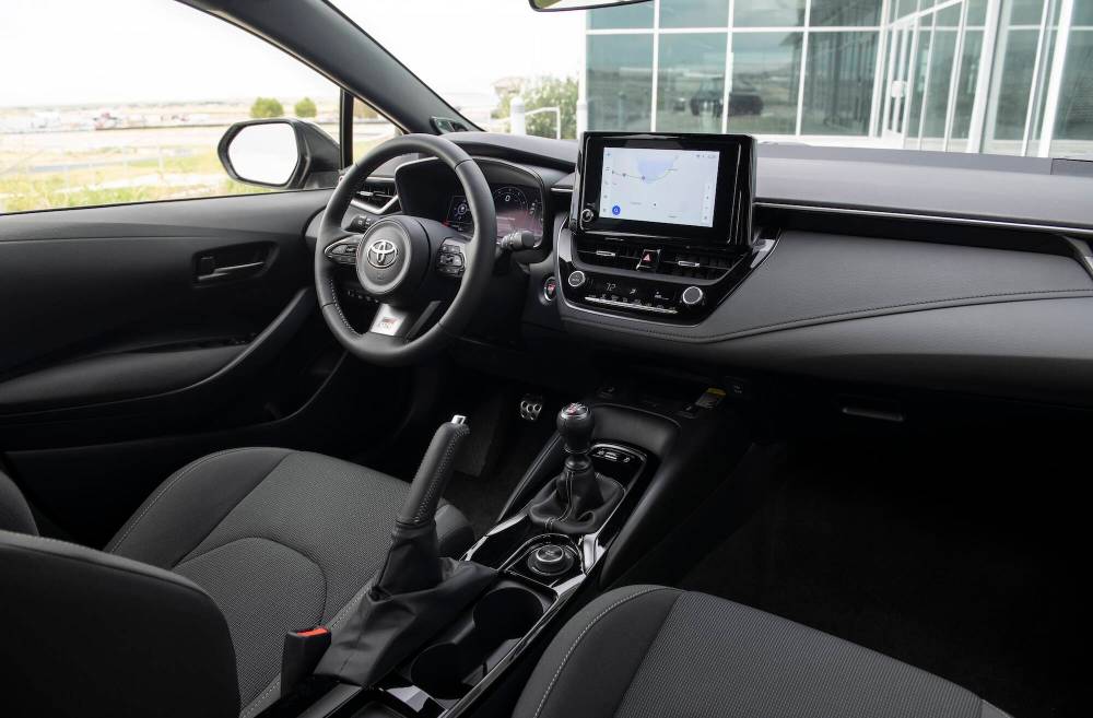 Supplied
Inside, the GR Corolla is heavily reminiscent of regular Corollas, but with a cool, customizable instrument panel (inset) and, behind the shift lever, a three-position switch to alter the split of all-wheel drive torque.