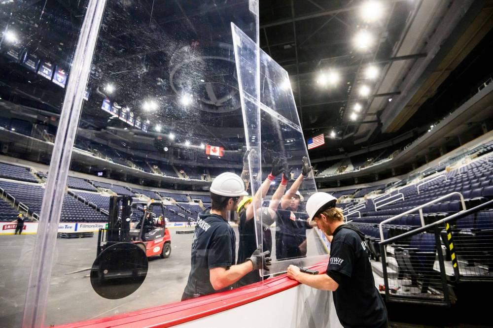 MIKE SUDOMA / FREE PRESS Communication is key with the Crew members as they work to take out the glass from the boards at Canada Life Centre Wednesday morning Nov 13, 2024