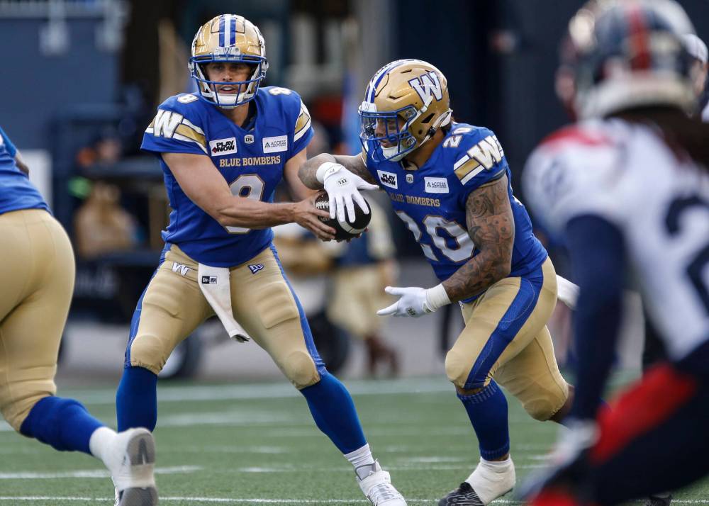 THE CANADIAN PRESS/John Woods
Winnipeg Blue Bombers quarterback Zach Collaros (8) hands-off to Brady Oliveira (20) during first half CFL action against the Montreal Alouettes in Winnipeg Thursday, June 6, 2024.