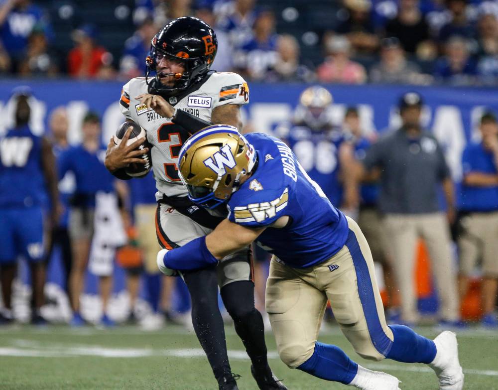 THE CANADIAN PRESS/John Woods
B.C. Lions quarterback Vernon Adams Jr. (3) gets sacked by Winnipeg Blue Bombers’ Adam Bighill (4) during second half CFL action in Winnipeg Thursday, August 1, 2024.