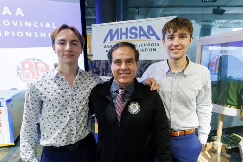 MIKE DEAL / FREE PRESS
                                Gabrielle-Roy Les Roys boys volleyball team members, Martin de Moissac (left), Alek Ouimet (right) and with Coach Michel Lavergne have won three consecutive provincial AA titles and are now looking to capture the AAAA crown.
