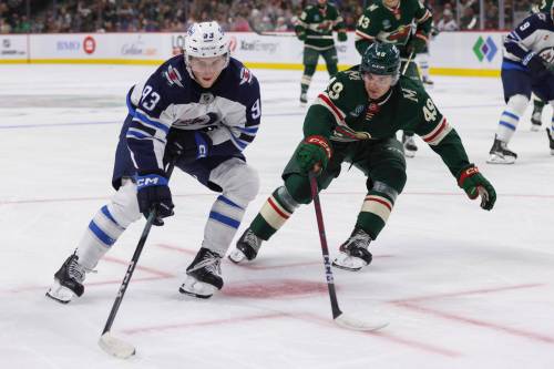 Bailey Hillesheim / The Associated Press files
                                Jets centre Brad Lambert (left) had an assist in his NHL regular-season debut last spring.
