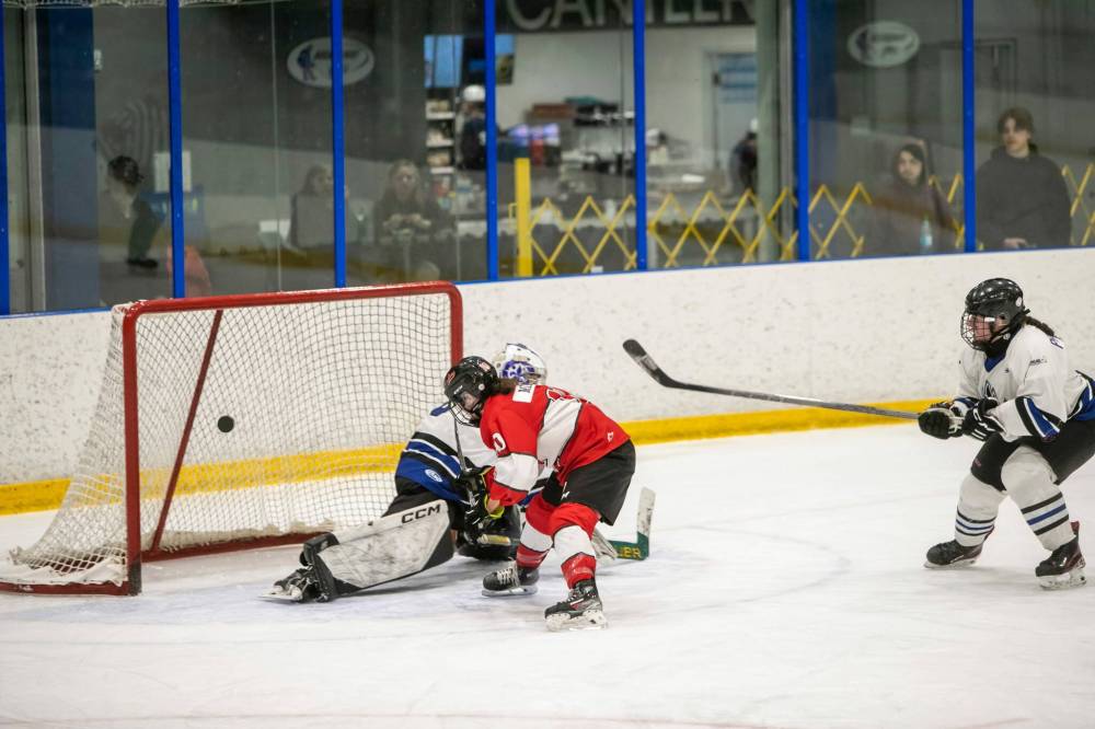BROOK JONES/FREE PRESS
Lions team captain and forward Chloe Minkus puts the puck past Olympiens goaltender Celeste Pelletier as she scores the third goal of the game on breakaway for Glenlawn during third period action.