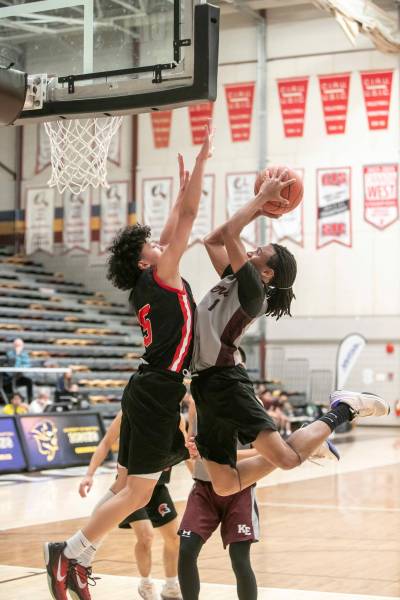 BROOK JONES/FREE PRESS
                                Kildonan-East Reivers guard Rushawn Martin (right) drives to the hoop as Sisler Spartans guard Jacob Medina covers him.