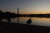 FILE - A mallard duck rests on the edge of a path around the Tidal Basin as the sun rises in Washington, Sunday, March 5, 2023, with the Washington Monument in the background. (AP Photo/Manuel Balce Ceneta, File)