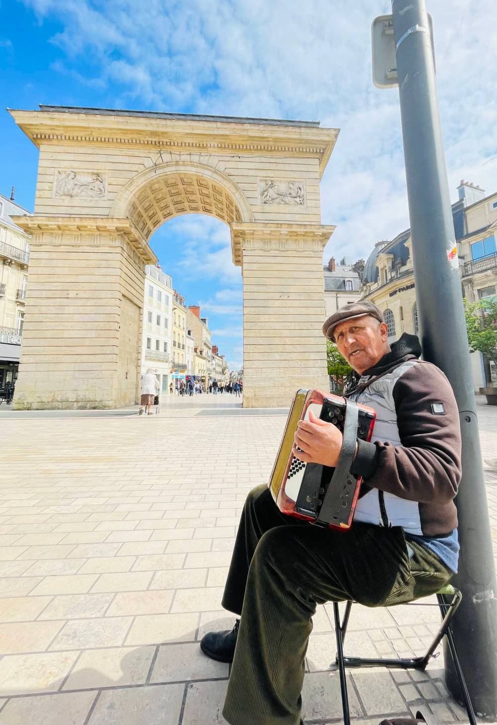 A busker plays the accordion at Dijon’s William Gate.