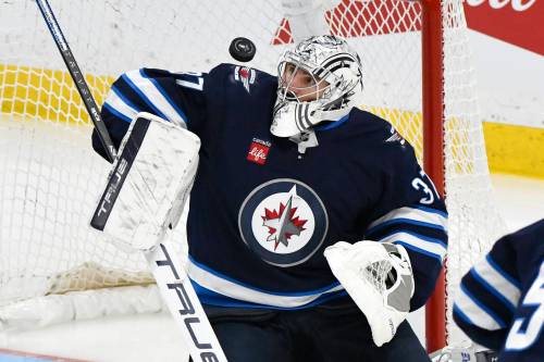 Winnipeg Jets goaltender Connor Hellebuyck (37) makes a save on a St. Louis Blues shot on April 21. (Fred Greenslade / The Canadian Press files)