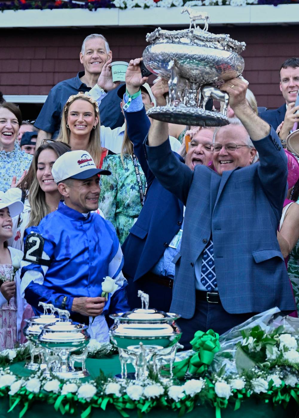 JESSICA HILL / THE ASSOCIATED PRESS
Trainer Bill Mott (right) lifts the August Belmont trophy as jockey Junior Alvarado looks on after winning the 157th running of the Belmont Stakes with Sovereignty.