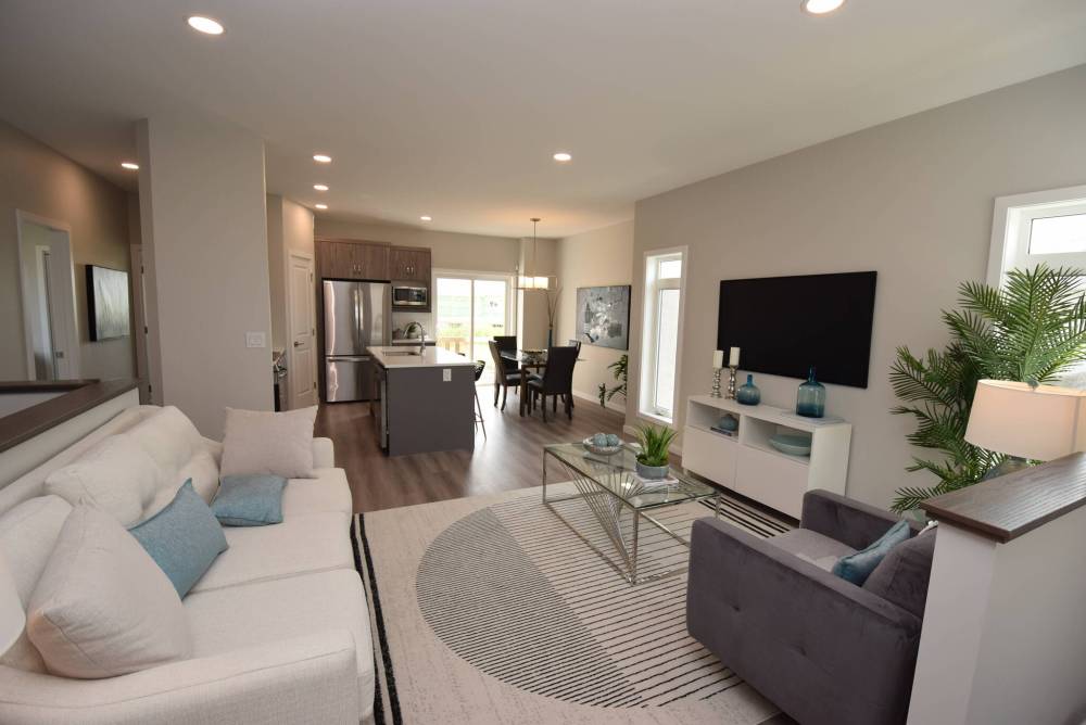TODD LEWYS / FREE PRESS
The flow from the living room into the kitchen and dining areas is fantastic at both 81-100 Grande Pointe Meadows Blvd. (top) and 29-100 Grande Pointe Meadows Blvd. (bottom).