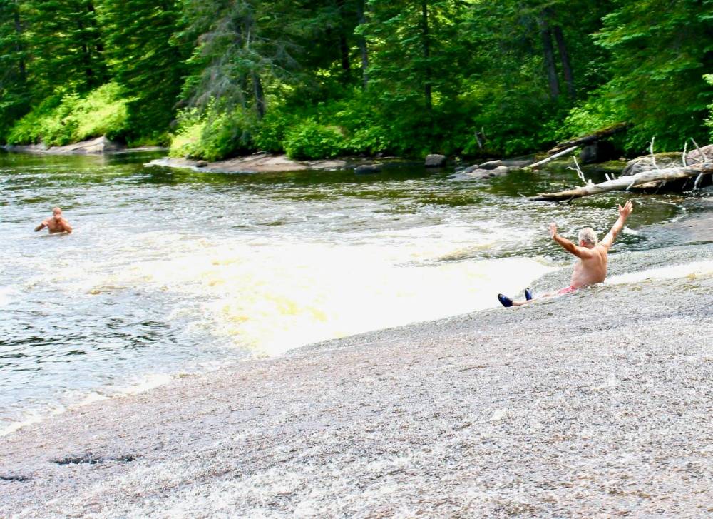 MARGARET MACKINTOSH PHOTO
The author slides at Pine Point Rapids during high water — for a photo.
