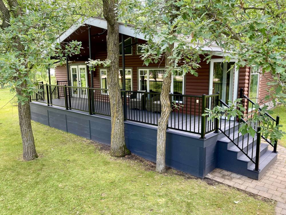 MARC LABOSSIERE / FREE PRESS
The old lumber tops and skirt were removed from this covered front porch and replaced with two-tone composite decking and aluminum railings.