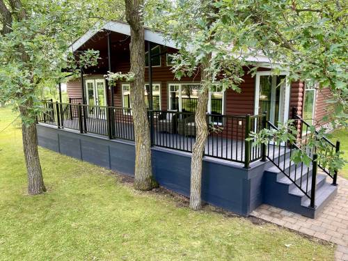 MARC LABOSSIERE / FREE PRESS
                                The old lumber tops and skirt were removed from this covered front porch and replaced with two-tone composite decking and aluminum railings.