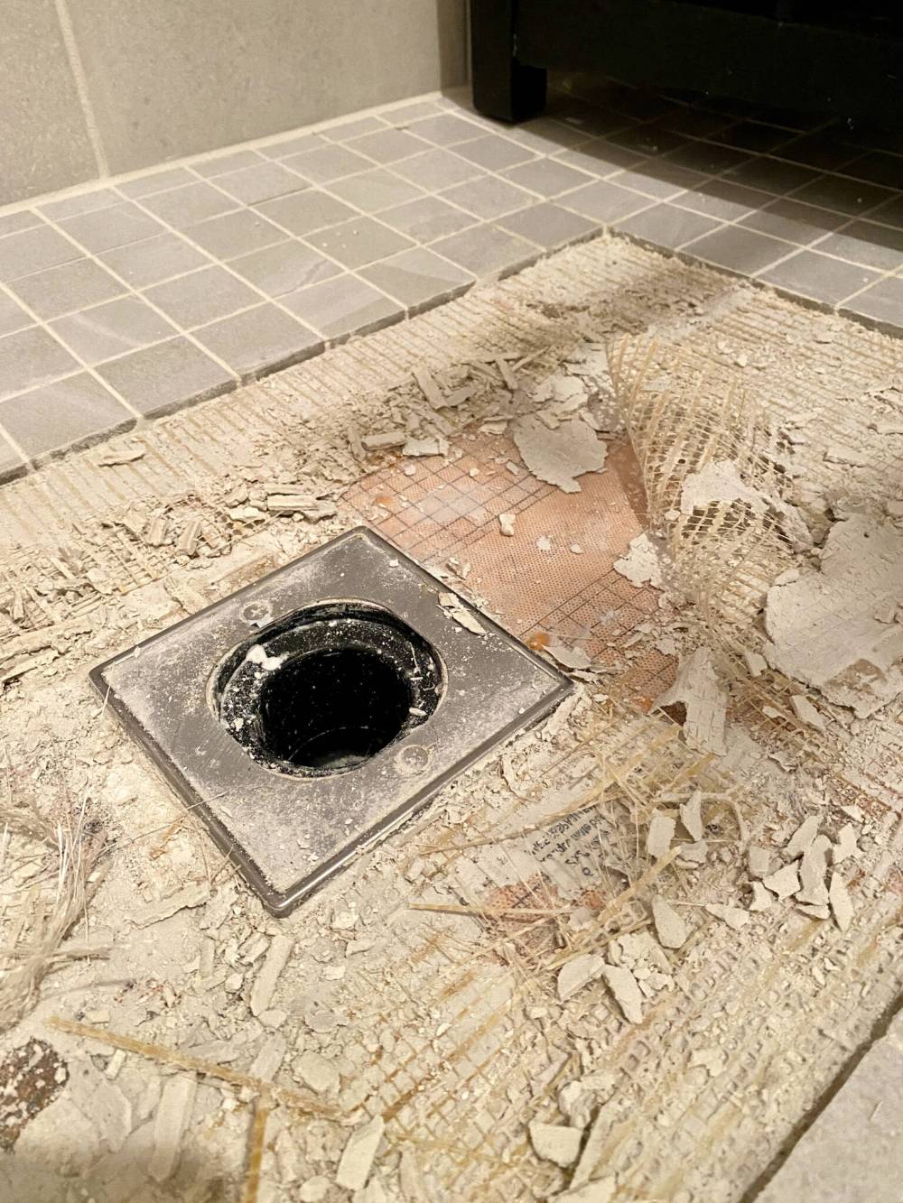 After a few shower tiles revealed cracked grout, further assessment revealed thinset that had never fully cured.