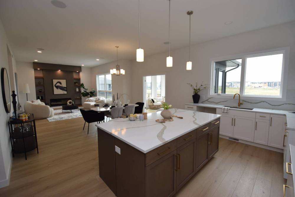 TODD LEWYS / FREE PRESS
Natural light, plenty of space and luxurious finishings give the main living area at 55 Siddiqui Ridge, Bison Run, a warm and inviting ambience.