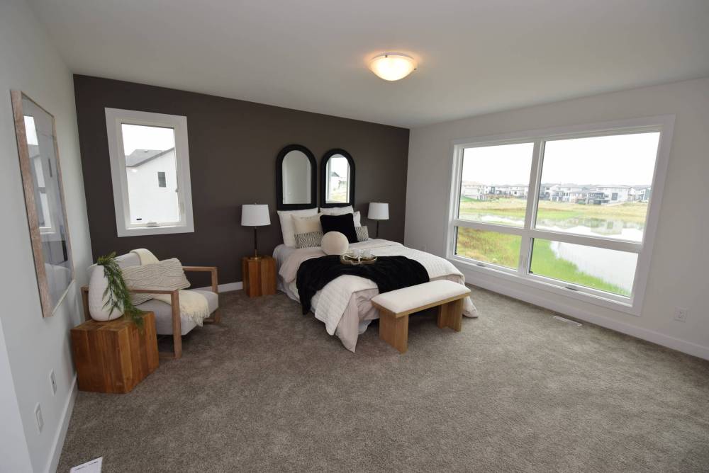 TODD LEWYS / FREE PRESS
The tranquil primary bedroom also boasts an expansive water view.