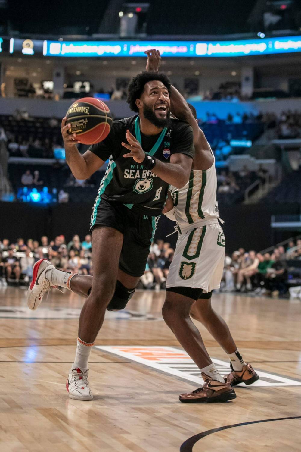 BROOK JONES / FREE PRESS
Sea Bears forward Maurice Callo (No. 9) drives to the hoop with the basketball while Rattlers guard Devonte Bandoo (No. 0) covers him during first quarter action.