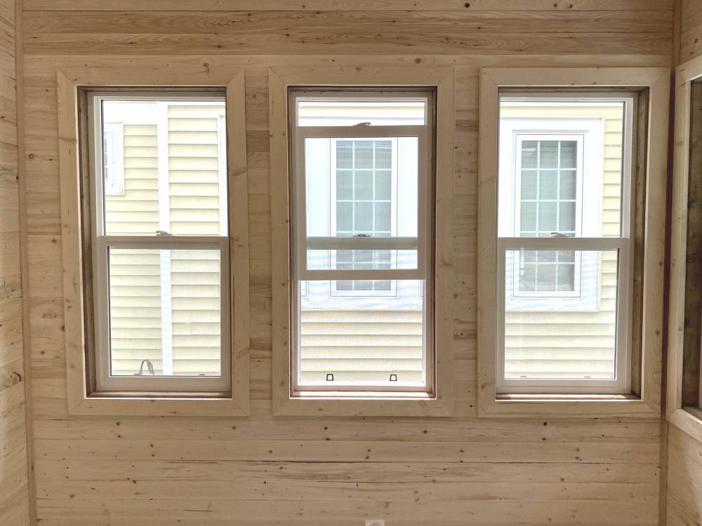 The window casings consist of 1 x 3 pine trim boards, which blend perfectly with the knotty pine walls.