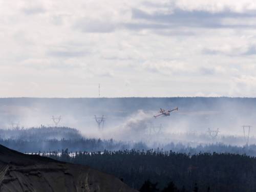 Elling Lien / THE CANADIAN PRESS
                                A water bomber drops water onto a wildfire burning in the Paddy’s Pond area just outside St. John’s on Wednesday. Baseball games taking place in Mount Pearl have had to relocate to the provincial capital due to the smoke from the Paddy’s Pond fire.