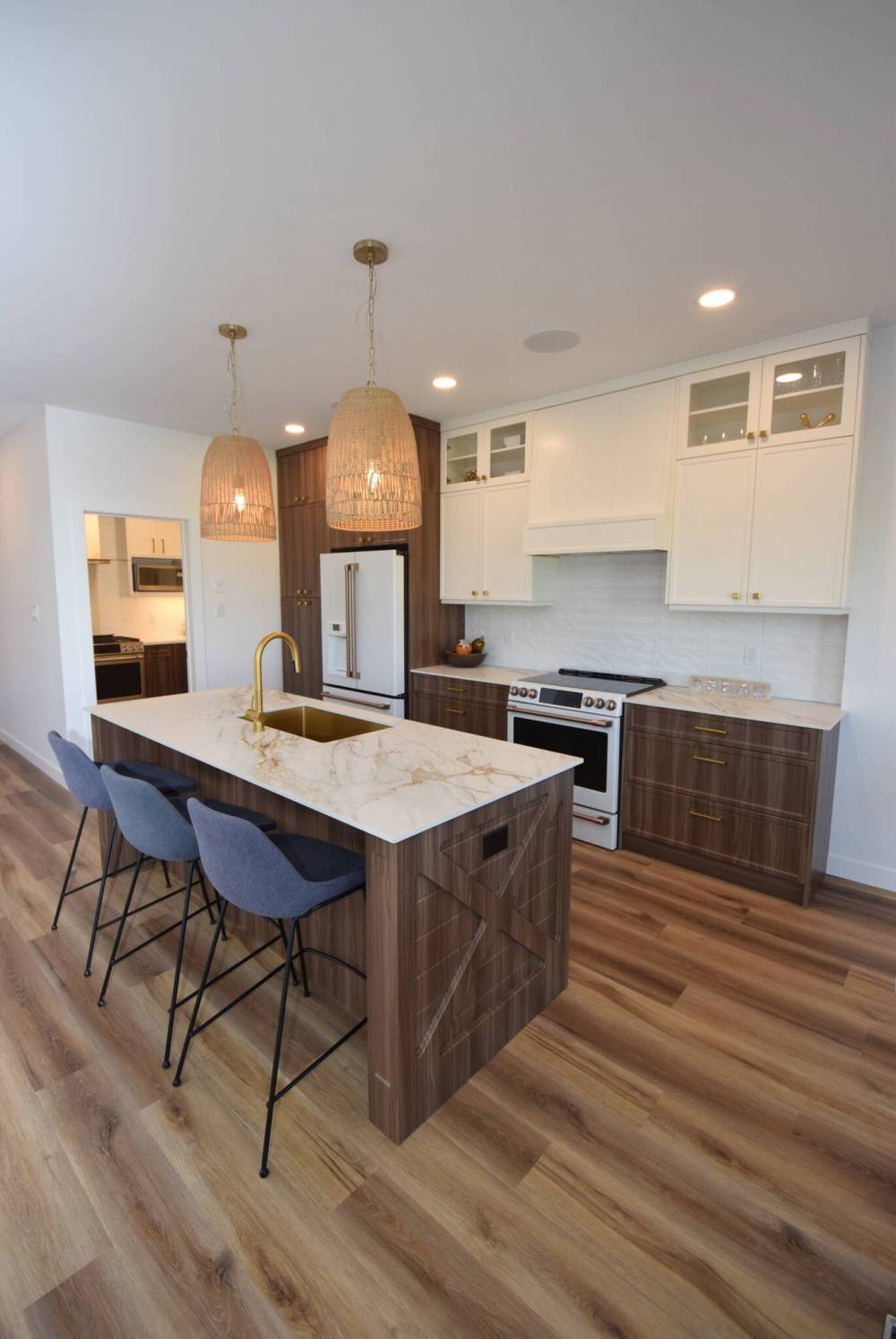 Todd Lewys / Free Press
The island kitchen at 23 Yaleton St., Prairie Pointe, features white appliances with a whole new feel, thanks to a matte finish and champagne bronze door bling.