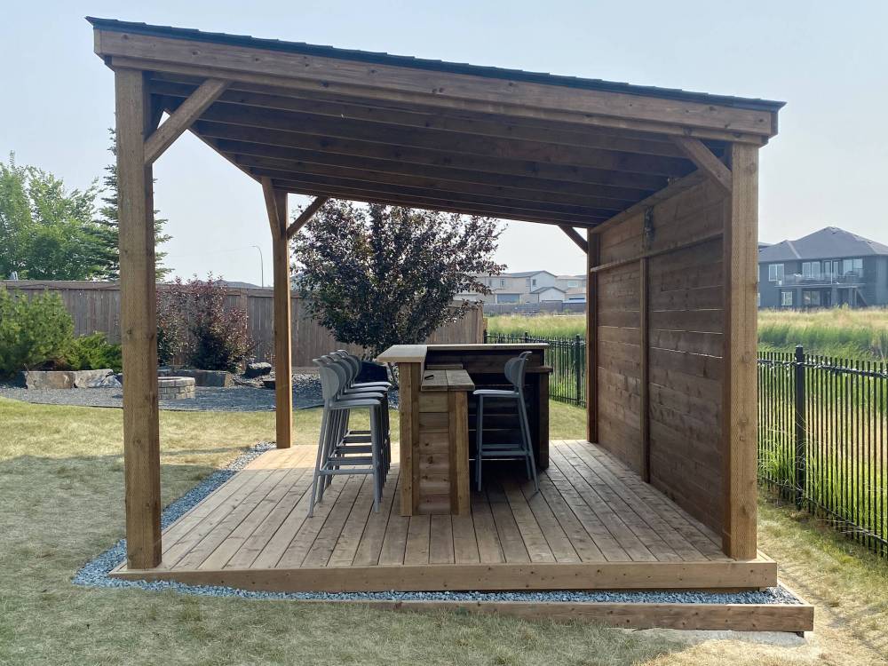Due to the slope of the yard, the ground was excavated and concrete pads installed before the deck was framed.
