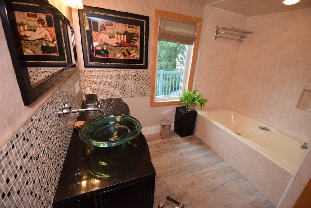 The elegant primary bedroom’s ensuite is a private retreat.