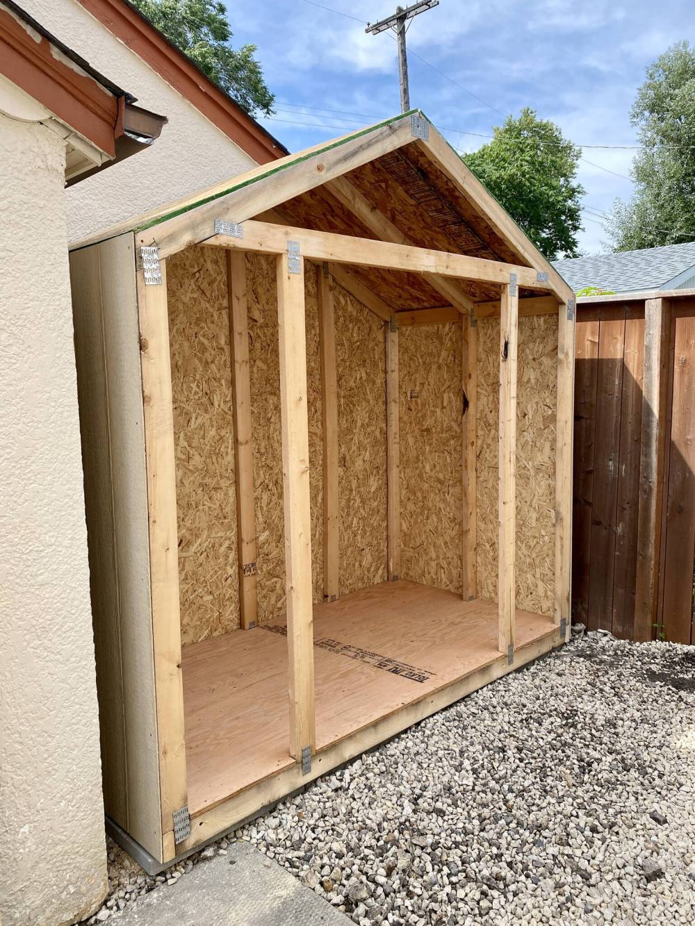 Once the shed’s main framing was done, it was moved into position atop concrete pads next to the garage.