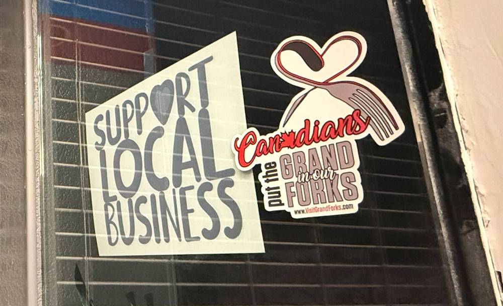 Earlier this year, Grand Forks’ tourism arm gave stickers to businesses to hang in their store windows, reminding Canadians that they “put the Grand in our Forks.” (Scott Billeck / Free Press files)