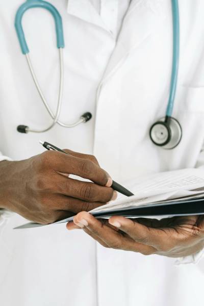 Ivan Samkov / Pexels
                                Doctors writing notes to verify illness is taxing the health care system.