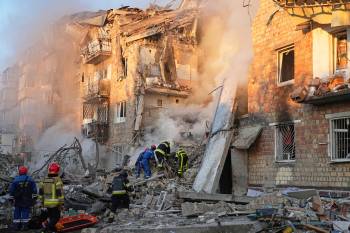 Efrem Lukatsky
                                Firefighters work at the site of a burning building after a Russian attack in Kyiv, Ukraine in August.