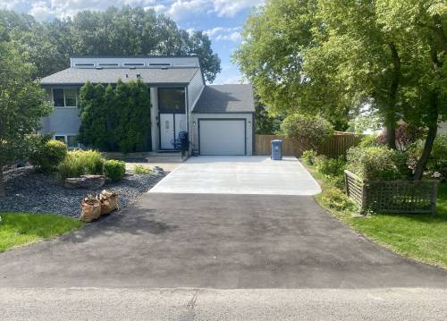 Marc LaBossiere photos / Free Press
                                To avoid added costs due to recent changes in city code, the old driveway approach was retained and topped with asphalt, while the concrete driveway pad was completely replaced.
