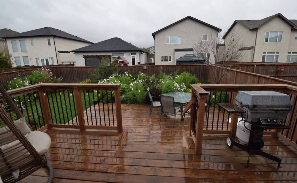 TODD LEWYS / FREE PRESS
The backyard, with its two-tiered deck and gorgeous gardens, is a great spot to relax and entertain.