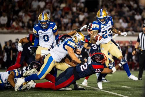 Winnipeg Blue Bombers’ Trey Vaval (23) runs with the ball during first half CFL action against the Montreal Alouettes in Montreal during the Aug. 21 game. (Christopher Katsarov / The Canadian Press files)