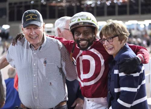 Jason Halstead / Assiniboia Photo
                                Owner Gary Danelson (left), jockey Antonio Whitehall (centre) and owner Bonnie McCrory celebrate in the winner’s circle after winning the Winnipeg Futurity with Omaha Warrior.