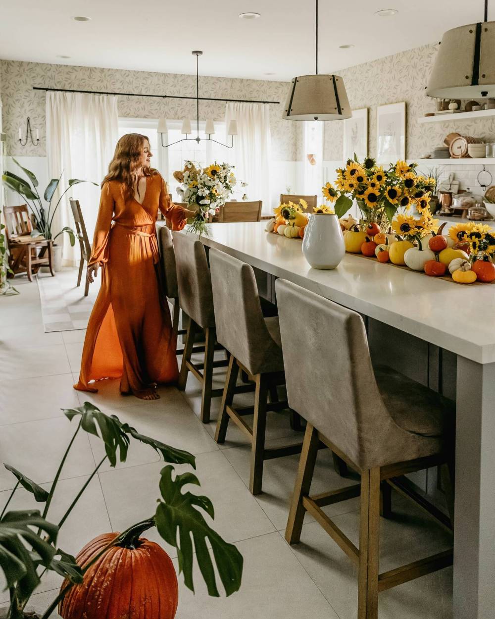 Zinnia blooms are paired with mini pumpkins in horns of plenty on the Thanksgiving table.