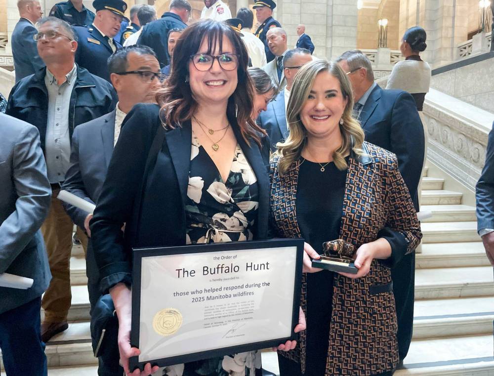 Ruth Bonneville / Free Press LOCAL - Order of the Buffalo Hunt Photo of Kristin Hayward, assistant deputy minister for the Manitoba Wildfire Service (left), and Christine Stevens, assistant deputy minister for the Manitoba Emergency Management Organization, hold the Order of the Buffalo Hunt awarded to them both by the Premier of Manitoba in a ceremony earlier for guiding the province through one of its most difficult wildfire seasons, at a special ceremony at the Legislative Building Thursday. They had their photo taken with a larger group of heroes who also were recognized for their emergency work helping with the Manitoba Wildfires this past summer. Hayward and Stevens, are two of Manitoba’s top emergency leaders that were recognized for guiding the province through one of its most difficult wildfire seasons in recent years. Oct 09, 2025