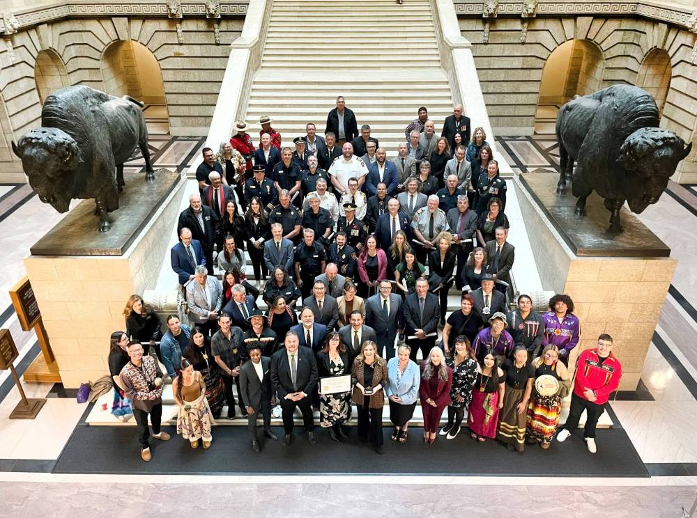 Ruth Bonneville / Free Press LOCAL - Order of the Buffalo Hunt Group photo Premier Wab Kinew is in the centre of a large group of heroes for their emergency work they did during the Manitoba Wildfires this past summer. A special presentation for the Order of the Buffalo Hunt was presented earlier to Kristin Hayward, assistant deputy minister for the Manitoba Wildfire Service, and Christine Stevens, assistant deputy minister for the Manitoba Emergency Management Organization, stand in the centre of the front row respectively with the group of heroes on the stairs of the Manitoba Legislative Building Thursday. Hayward and Stevens, are two of Manitoba’s top emergency leaders that were recognized for guiding the province through one of its most difficult wildfire seasons in recent years. Oct 09, 2025